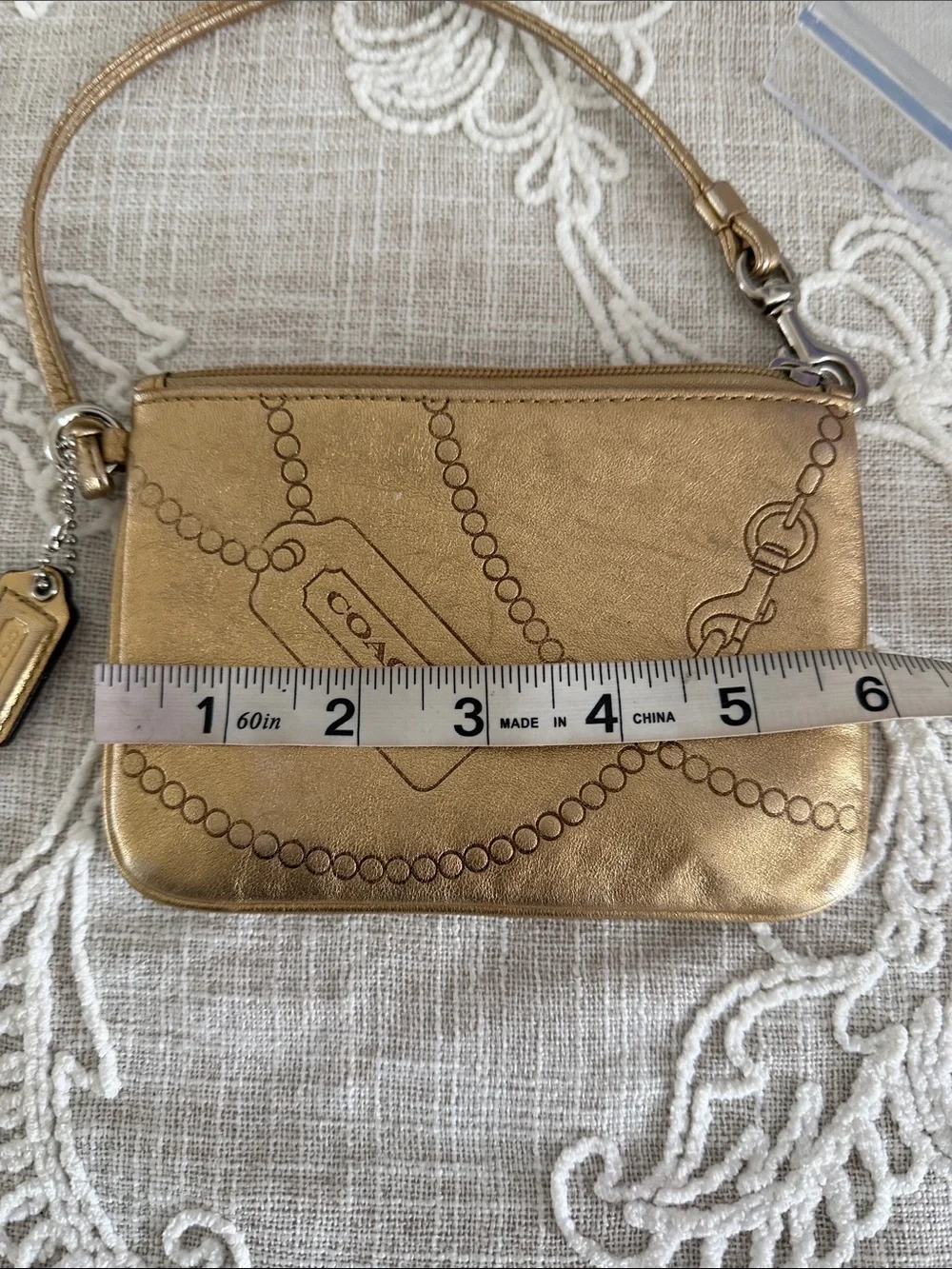 Coach Metallic Gold Wristlet with Embossed Chain Motif